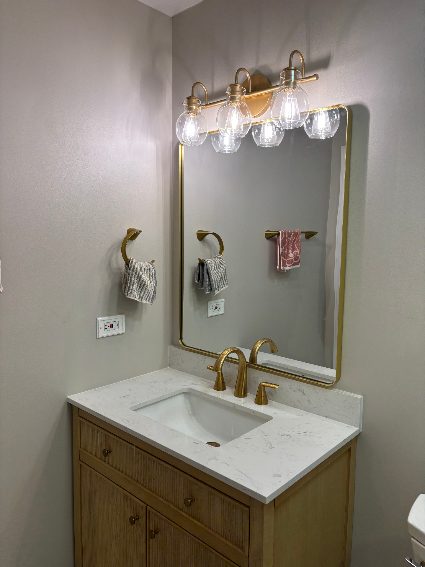 Custom vanity and brass fixtures in new Vernon Hills, IL bathroom addition