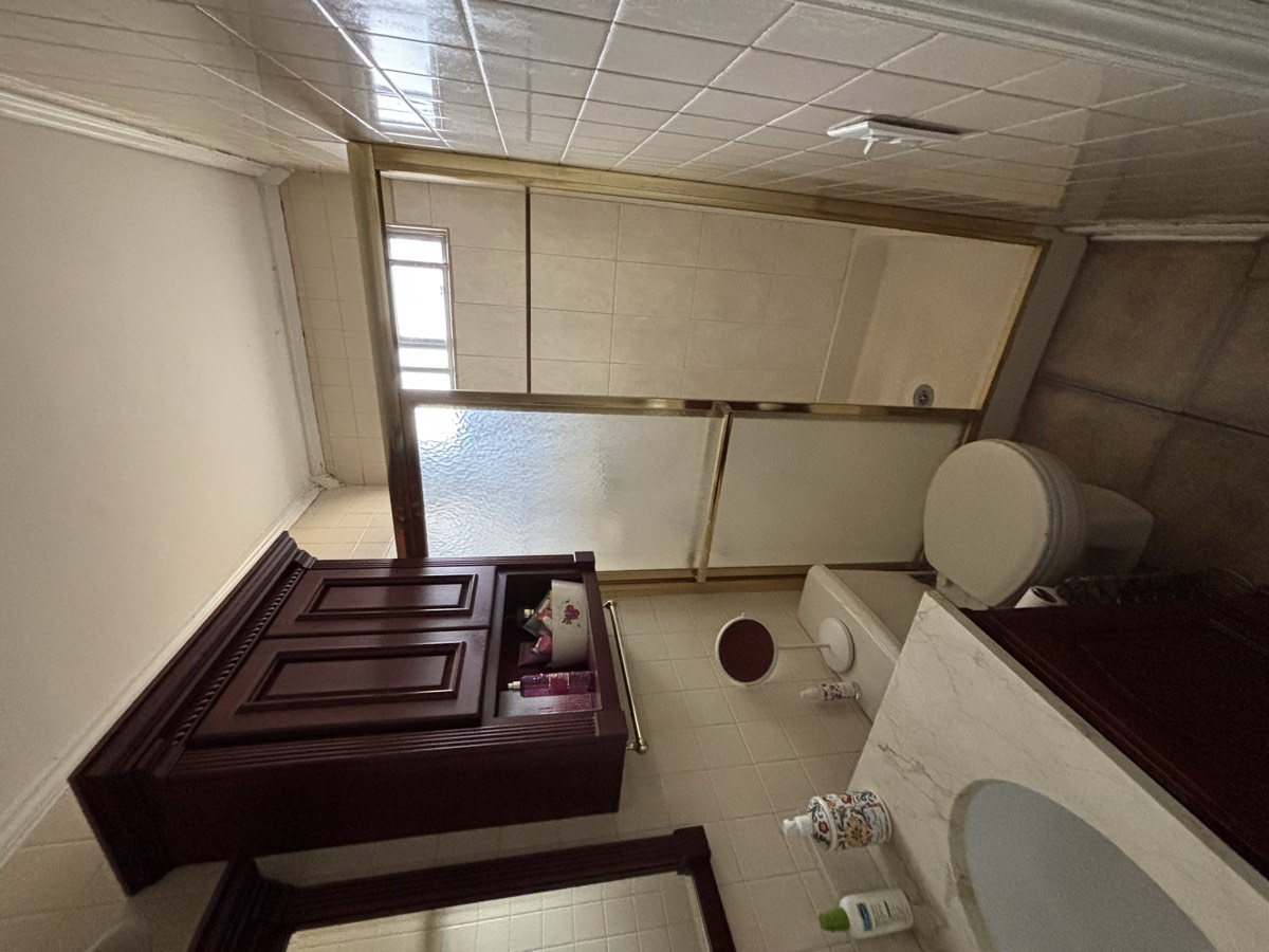 Before — dated gray tile shower and tub